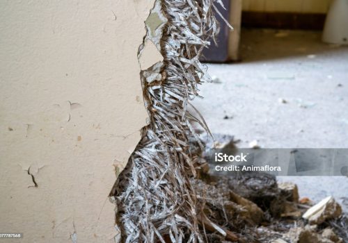 Old asbestos in a wall in the room, harmful to health